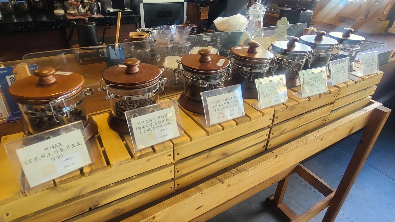 Coffee beans displayed in glass jars at Caffe Brazil Ponam