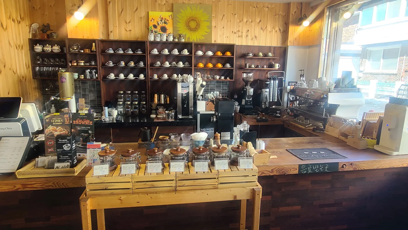 Wooden coffee counter with cups and brewing equipment at Caffe Brazil Ponam