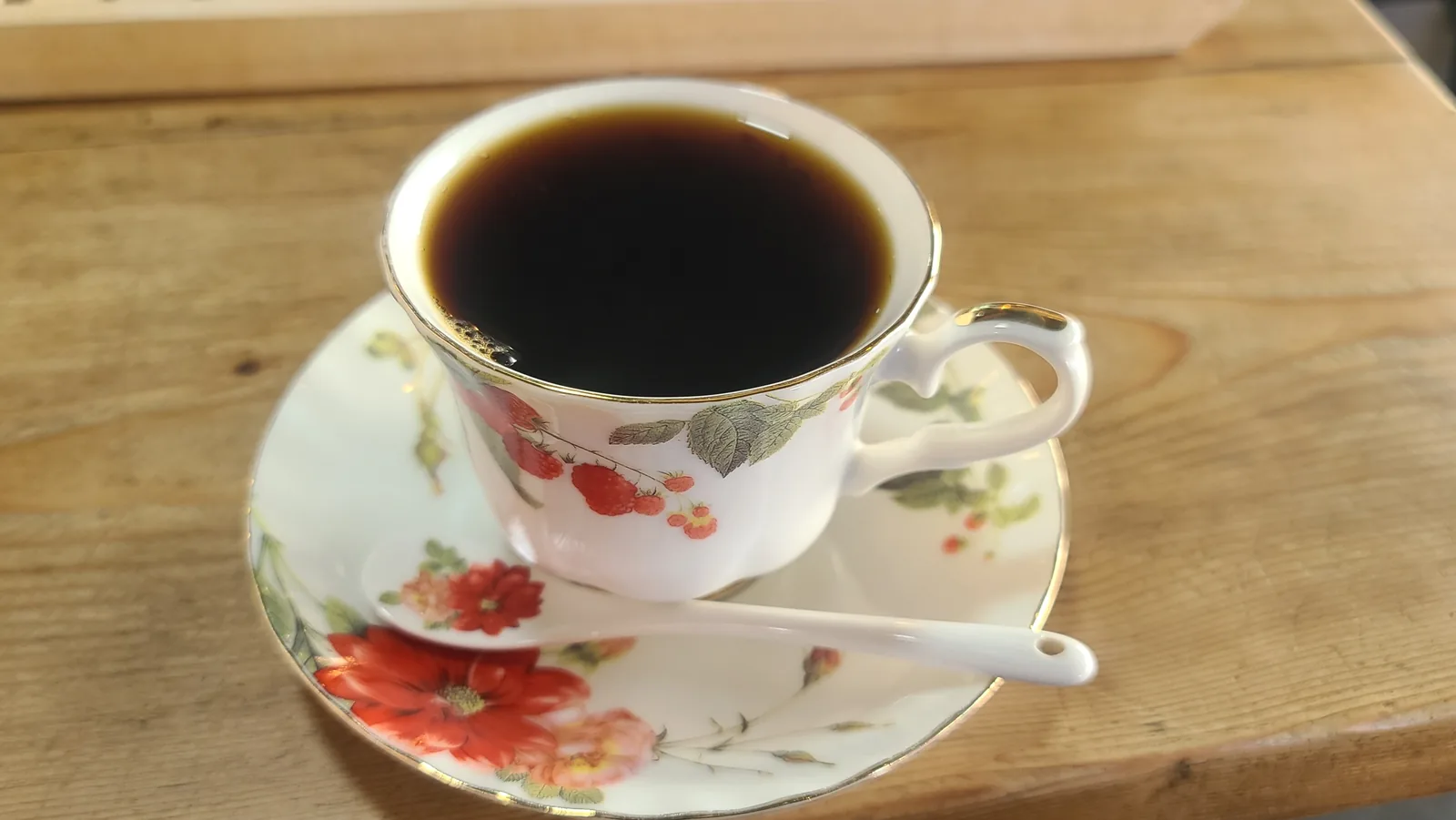 Guatemalan hand-drip coffee served in a floral cup at Caffe Brazil Ponam