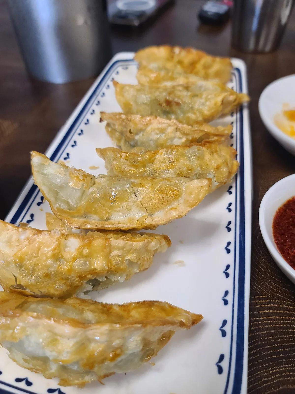 Golden fried dumplings on a rectangular plate at Ongsimi Junggukjip
